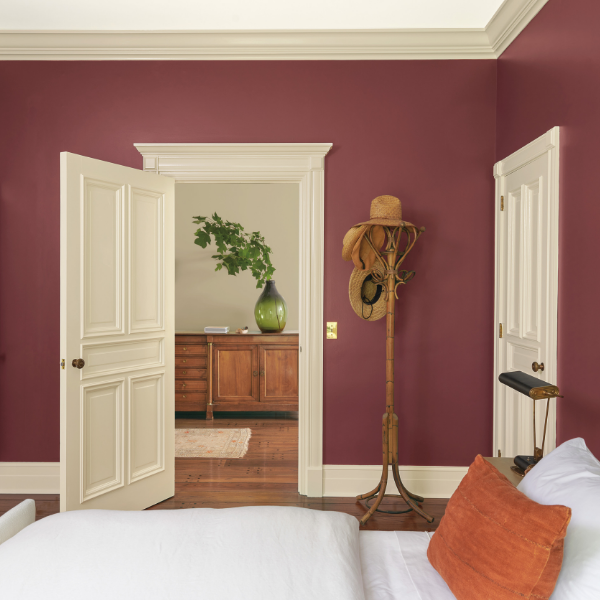 A beautiful bedroom featuring walls and trim painted in Benjamin Moore Historical Collection paint