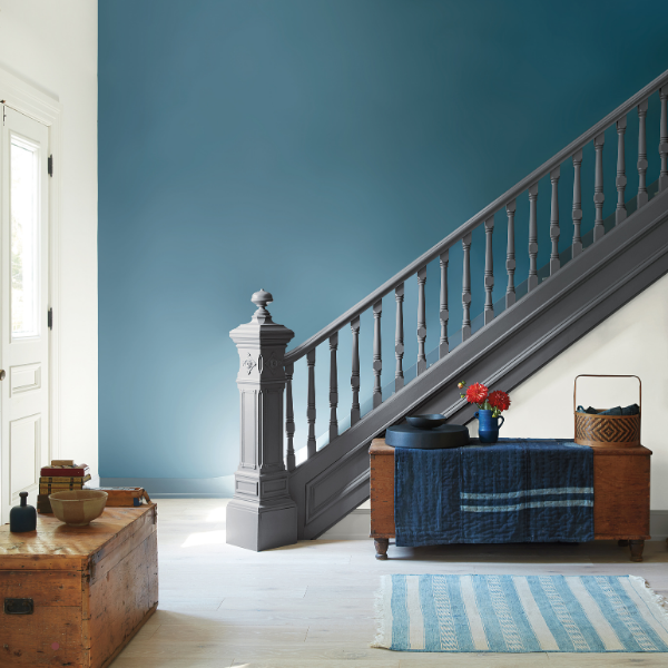 A stairway entryway with walls painted in Benjamin Moore Historical Color Collection paint