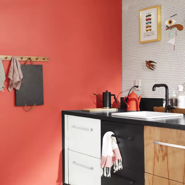 A kitchen featuring a bold red accent wall and cabinetry painted in Benjamin Moore Color Preview colors