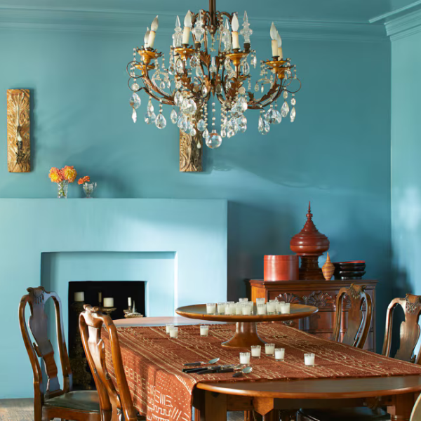 A historic dining room featuring bold blue walls and ceiling painted in Benjamin Moore Color Preview colors