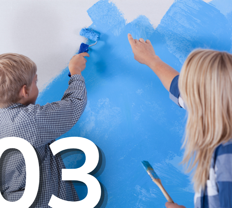 A woman teaching a young child how to paint an interior wall blue with a small paint roller